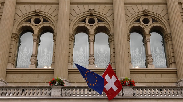  The flags of the European Union and Switzerland flutter in the wind.