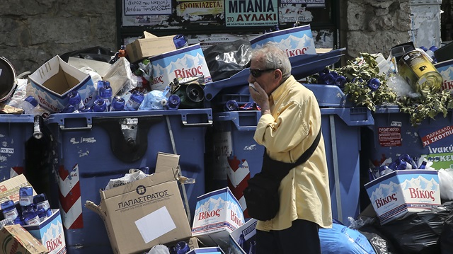 Greek garbage workers protest over jobs as trash piles grow