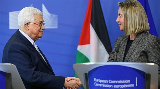Palestinian President Mahmoud Abbas (L) and High Representative of the European Union for Foreign Affairs and Security Policy Federica Mogherini (R) shake hands before holding a joint press conference after their meeting at the European Commission building in Brussels, Belgium on March 27, 2017. 