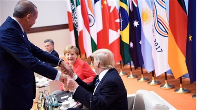 Merkel posted a photo of an exchange between Erdoğan (front left) and Trump (front right).