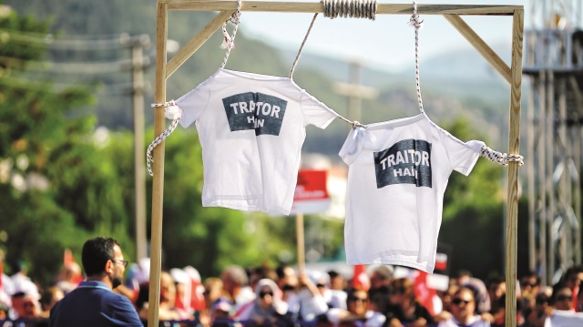 Vatandaşlar, “Hero” yazan tişörtle gelen sanık Gökhan Güçlü’ye tepkilerini “Hain” anlamındaki “Traitor” yazan tişörtler gösterdi.