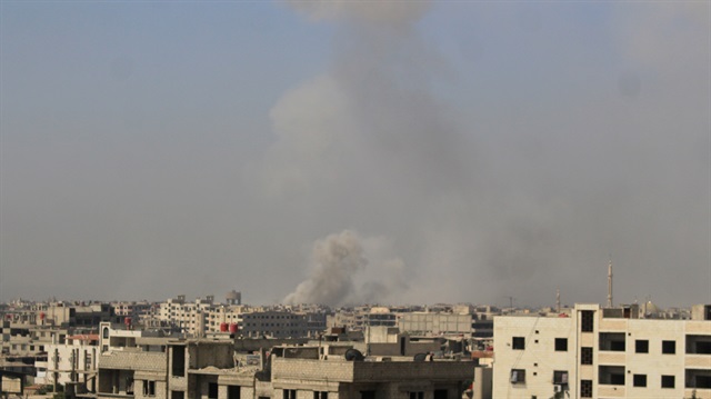 File photo: Smoke rises from buildings after Assad Regime's forces hit de-conflict zone of opposition controlled Ein Terma region in Damascus, Syria on July 18, 2017.