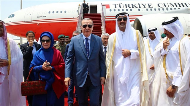 Turkish President Recep Tayyip Erdogan (C) and his wife Emine Erdogan (L) are welcomed by Emir of Qatar Sheikh Tamim bin Hamad Al Thani (C-R) in Doha, Qatar on July 24, 2017
