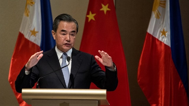 China’s Foreign Minister Wang Yi gestures during a joint press conference with Foreign Affairs secretary Alan Peter Cayetano in Manila on July 25, 2017.