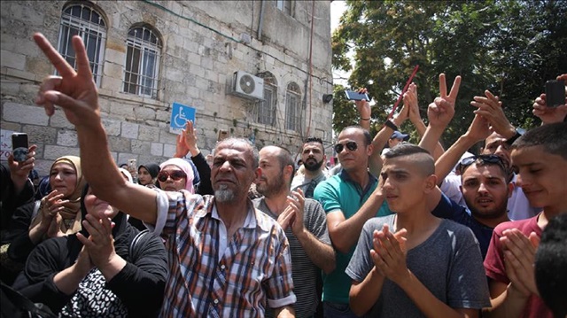 Palestinians celebrate in front of the Lion's Gate entrance to Al Aqsa mosque after more Israeli iron guardrails were removed from the Al-Aqsa Compound in Jerusalem, on July 27, 2017. While Palestinians immediately celebrated the removal at the Esbat Gate of Al-Aqsa some remained cautious.