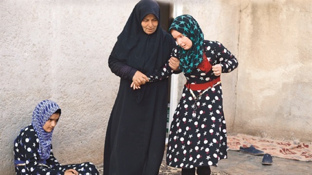 Thirty-nine-year-old mother Aisha Hussein al-Shuaybi, and her daughters who suffer from cerberal palsy