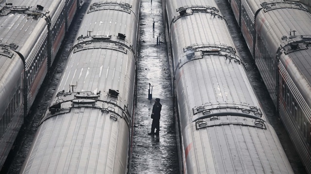 An employee stands near train carriages, owned by Russian Railways company, on the side tracks in Moscow, Russia, March 1, 2017.