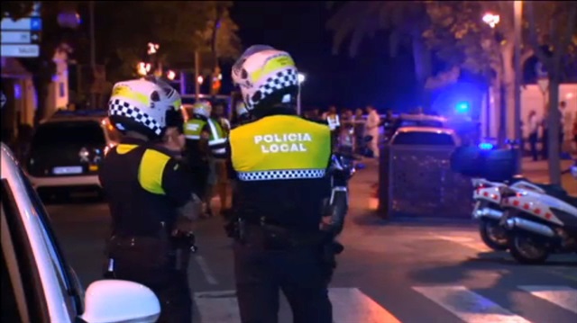 Officers investigate at the scene where police had killed four attackers in Cambrils