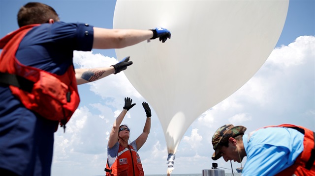 College of Charleston professor Dr. Cassandra Runyon (Center) releases a balloon during a test 