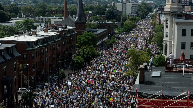 A large crowd of people march towards the Boston Commons to protest the Boston Free Speech rally