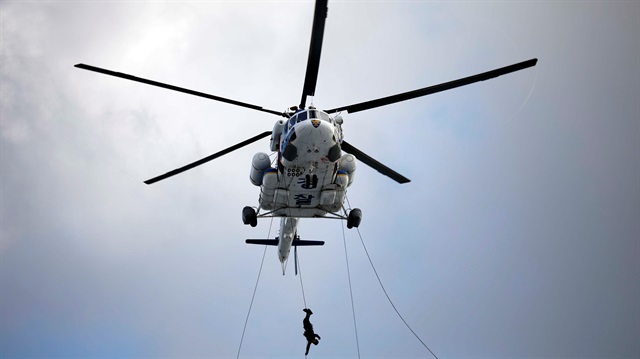 A member of Special Weapon and Tactics (SWAT) rappels down during an anti-terror drill 