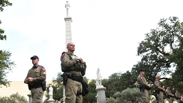 Texas state troopers stand guard over a confederate monument 