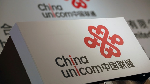 Company logos of China Unicom are displayed at a news conference during the company's announcement of its annual results in Hong Kong, China March 16, 2016. 