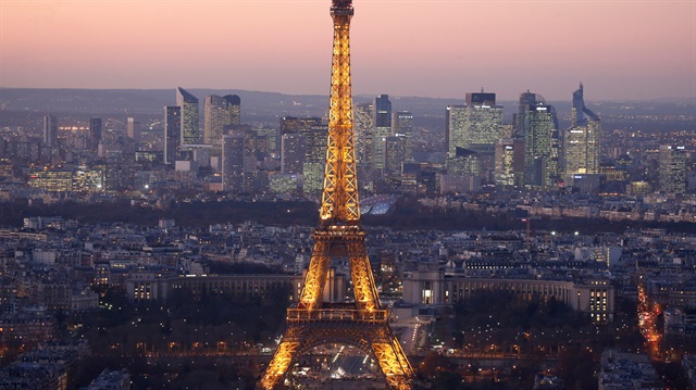  A view of the illuminated Eiffel Tower and the skyline La Defense business 