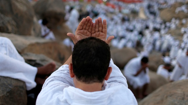 A Muslim pilgrim prays on Mount Mercy on the plains of Arafat during the annual haj pilgrimage