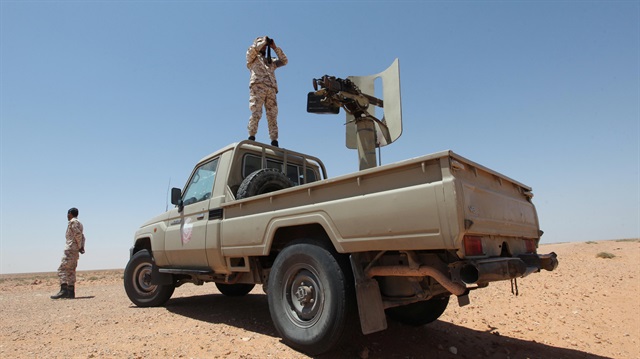 Libyan forces allied with the UN-backed government patrol