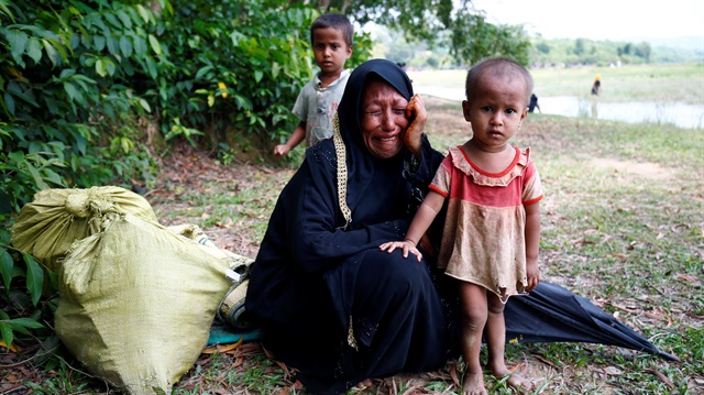 A Rohingya woman cries with her child, after being restricted by the members of Border Guards Bangladesh (BGB) to further enter the Bangladesh side, in Cox’s Bazar, Bangladesh August 28, 2017.