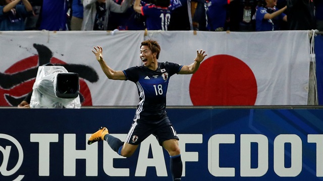 Japan's Asano Takuma celebrates his goal.