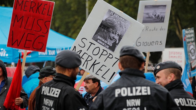 Members of Germany's far-right Alternative for Germany (AFD) party protest against Angela Merkel