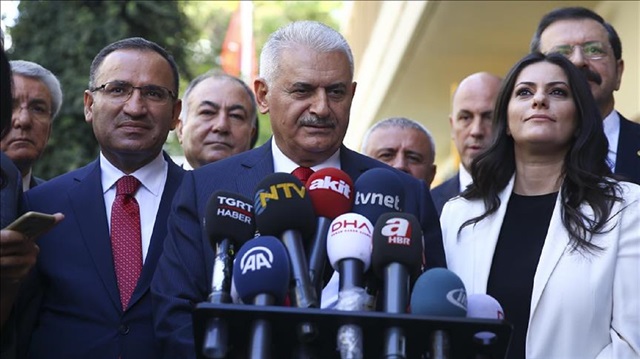 Turkish Prime Minister Binali Yildirim (C) speaks to media after visiting the Confederation of Turkish Trade Unions (TURK-IS) Headquarters in Ankara, Turkey on September 22, 2017.