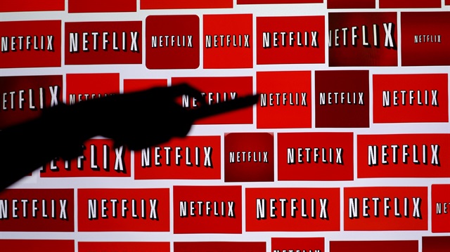 The Netflix logo is pictured on a television in this illustration 