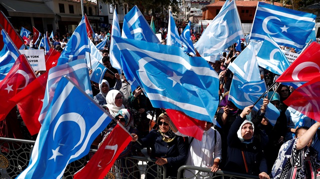 Demonstrators wave Turkish and Iraqi Turkmen (blue) flags during a protest 