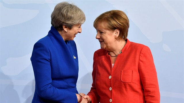 German Chancellor Angela Merkel greets British Prime Minister Theresa May