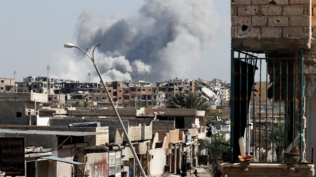 Smoke rises near the stadium in Raqqa