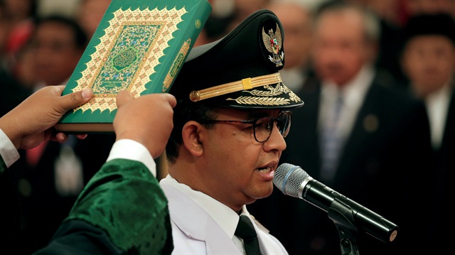 Jakarta Governor Anies Baswedan stands during a swearing-in ceremony at the Presidential Palace in Jakarta