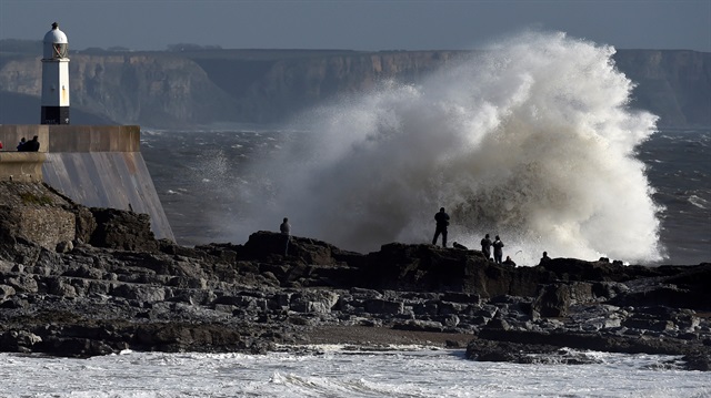 Waves crash over the lighthouse as storm Ophelia approaches Porthcawl, Wales, Britain.
