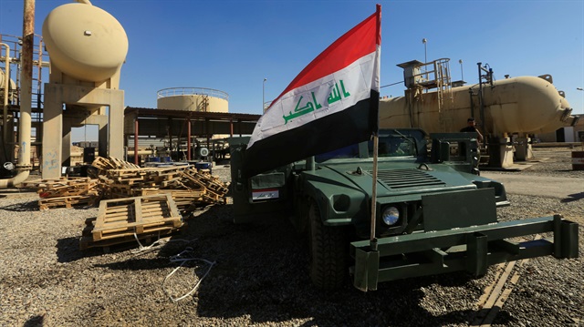 An Iraqi flag is seen on a military vehicle at an oil field in Dibis area on the outskirts of Kirkuk, Iraq.