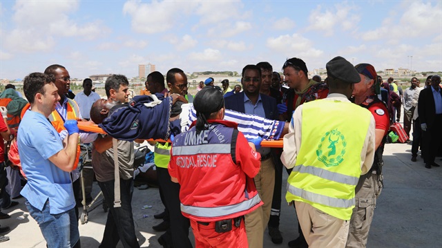Paramedicas assist a man wounded in the Mogadishu blast