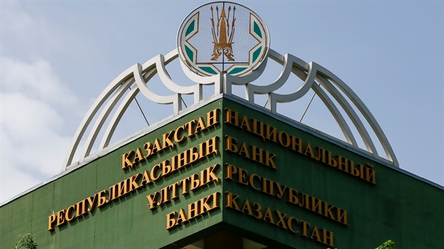 A bird flies above the logo of National Bank of Kazakhstan