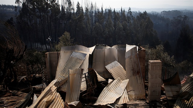 Wreckage of a burnt house is seen after a forest fire in Lagares