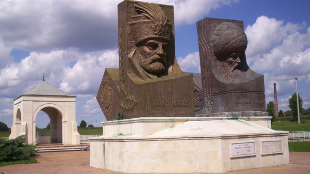 Head sculptures of Miklós Zrínyi (left) and Sultan Suleiman (right) with the symbolic tomb seen in the background at the Hungarian Turkish Friendship Park, Szigetvár