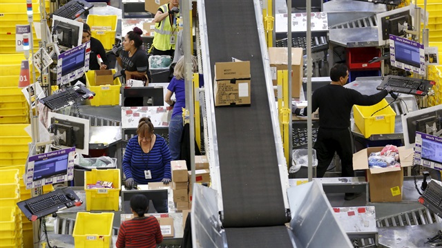 Workers prepare orders for customers at the Amazon Fulfillment Center in Tracy
