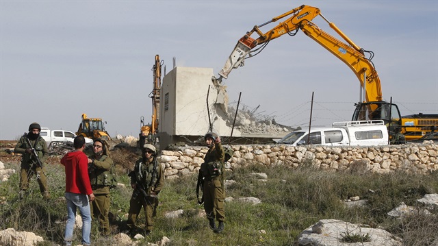 Reuters
A Palestinian man argues with Israeli soldiers during the demolition of a Palestinian house 