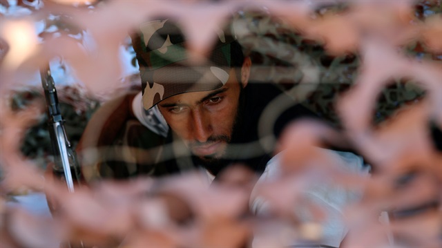 An opposition fighter sits at his position in Quneitra province, bordering the Israeli-occupied Golan Heights, Syria.