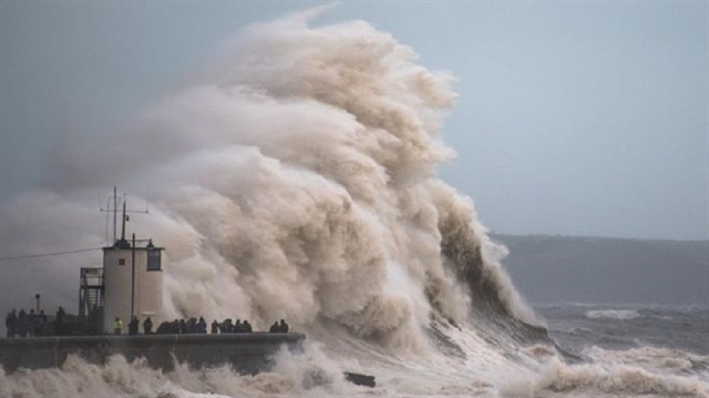 Waves crash over the cost in Porthcawl, Wales, as Storm Brian hits the UK.
