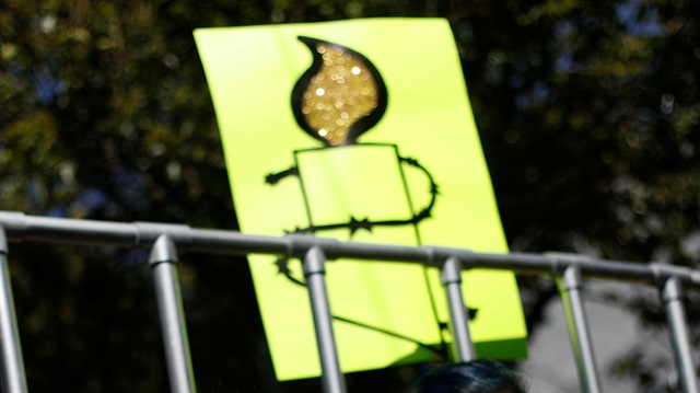 A member of Amnesty International holds sign 