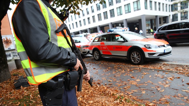 A German police officer guards the site where earlier a man injured several people in a knife attack in Munich, Germany.