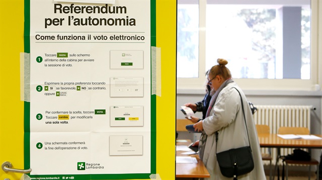 A poster with instructions about Lombardy's autonomy referendum is seen at a polling station in Lozza near Varese, northern Italy.