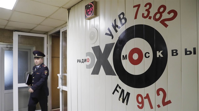 An Interior Ministry officer walks inside the office of Russian radio station Ekho Moskvy, after an intruder attacked the station's anchor Tatyana Felgengauer in Moscow, Russia.