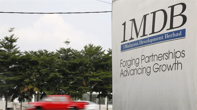 Traffic passes a 1Malaysia Development Berhad (1MDB) billboard at the Tun Razak Exchange development in Kuala Lumpur, Malaysia.