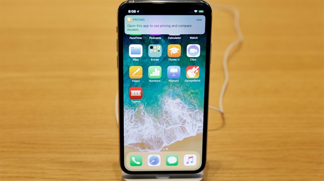 An iPhone X is displayed on a table at an Apple store in New York