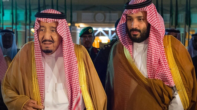Saudi Arabia's King Salman bin Abdulaziz Al Saud walks with his son and Crown Prince Mohammed bin Salman
