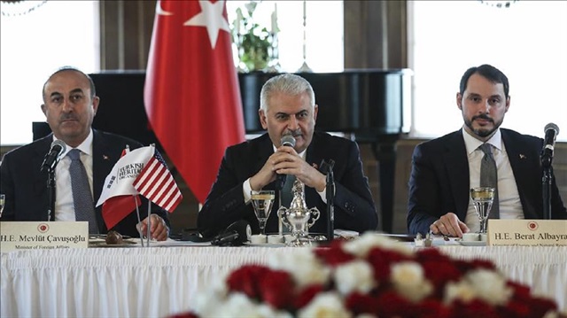 Turkish Prime Minister Binali Yıldırım (C) makes a speech with Turkish Foreign Minister Mevlüt Çavuşoğlu (L) and Turkish Energy and Natural Resources Minister Berat Albayrak (R) during a meeting with countries' opinion leaders at the Turkish Embassy in Washington, USA on November 08, 2017.