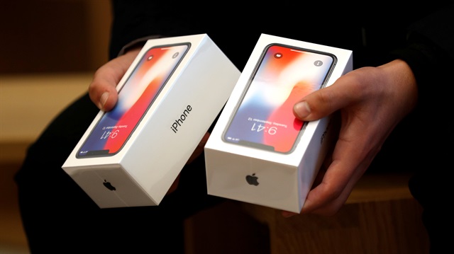 A man holds two boxes for the Apple's new iPhone X at the Apple Store