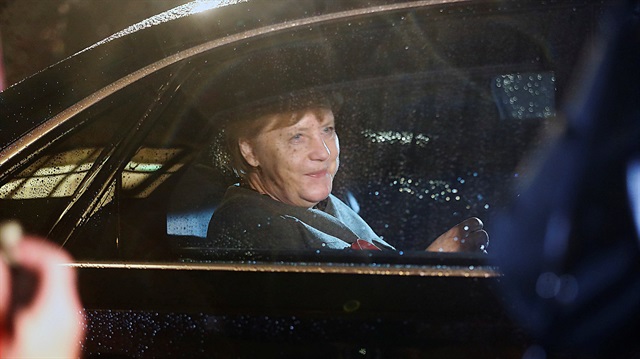 German Chancellor Merkel of the Christian Democratic Union leaves the German Parliamentary Society after exploratory talks about forming a new coalition government in Berlin