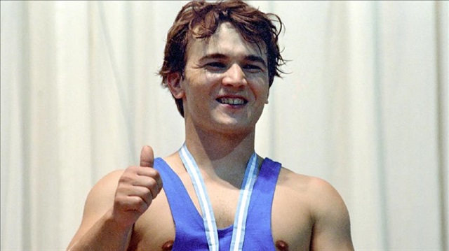 A file photo dated July 1, 1991 shows World and Olympic champion in weightlifting, Naim Suleymanoglu of Turkey, posing for a photo with his gold medal after the 11th Mediterranean Games in Athens, Greece on July 1, 1991.